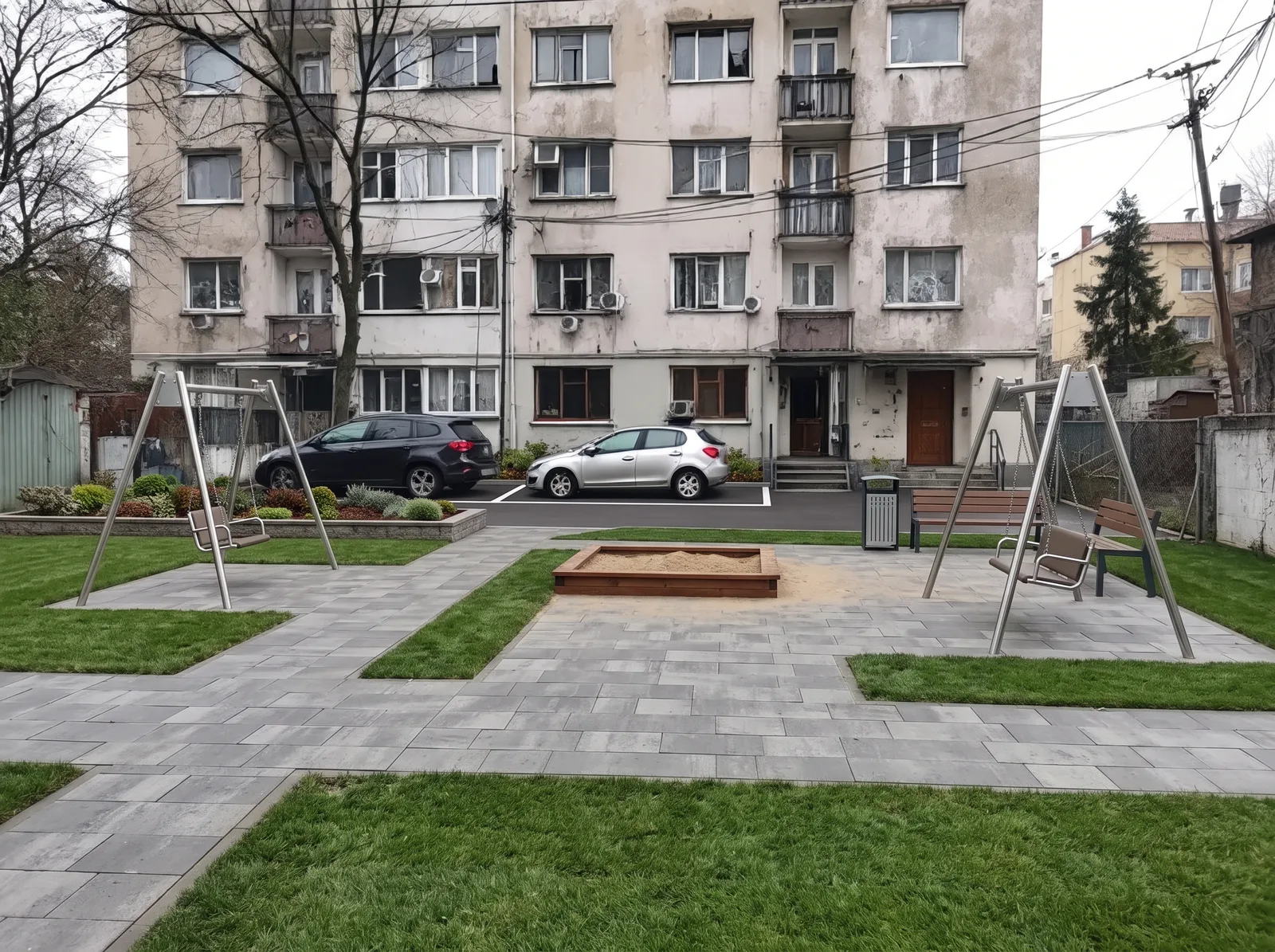 The whole yard: even paving instead of broken asphalt, lawn, benches and planting. The building is untouched.